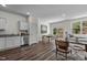 Open living area with hardwood floors and kitchen counter and dining room table at 121 N Chubb Rdg, Wilson's Mills, NC 27520