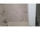 Modern bathroom features white marble-patterned tiled walls and a clean, white tub at 1222 Teakwood Pl, Raleigh, NC 27606