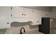 Kitchen featuring white cabinets and stainless steel refrigerator at 1222 Teakwood Pl, Raleigh, NC 27606