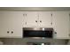 Kitchen featuring white cabinets and stainless steel microwave at 1222 Teakwood Pl, Raleigh, NC 27606