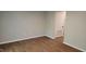 Clean and bright living room with vinyl floors next to a door to a storage area at 1222 Teakwood Pl, Raleigh, NC 27606