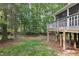 View of the backyard showing mature trees surrounding the yard and wooden deck at 13017 Townfield Dr, Raleigh, NC 27614
