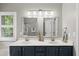 Bathroom features double sinks with blue cabinetry and a glass enclosed shower at 13017 Townfield Dr, Raleigh, NC 27614
