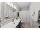 Well-lit bathroom with a large mirror, vanity, and a shower with a curtain at 13017 Townfield Dr, Raleigh, NC 27614