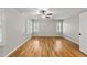 Spacious bedroom with hardwood floors, neutral walls, and bright, shuttered windows at 13017 Townfield Dr, Raleigh, NC 27614
