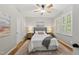 Cozy bedroom featuring a queen-sized bed, stylish nightstands, and ample natural light at 13017 Townfield Dr, Raleigh, NC 27614