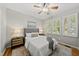 Comfortable bedroom with a ceiling fan, natural light, and a neutral color scheme at 13017 Townfield Dr, Raleigh, NC 27614