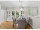 Bright dining area featuring hardwood floors, a modern chandelier, and access to outdoor space at 13017 Townfield Dr, Raleigh, NC 27614