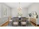 Bright dining room features a modern chandelier and a stylish rug over hardwood floors at 13017 Townfield Dr, Raleigh, NC 27614