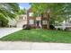 Charming two-story home boasts a brick and siding facade, complemented by a well-manicured lawn at 13017 Townfield Dr, Raleigh, NC 27614