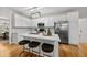 Modern kitchen featuring white cabinetry, stainless steel appliances, and a center island with seating at 13017 Townfield Dr, Raleigh, NC 27614