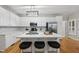 Modern kitchen with white cabinetry, stainless steel appliances, and a large island with seating at 13017 Townfield Dr, Raleigh, NC 27614