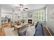 Spacious living room with fireplace, ceiling fan, and neutral decor with wood floors at 13017 Townfield Dr, Raleigh, NC 27614