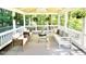 Bright and airy screened patio furnished with stylish seating, perfect for enjoying the outdoor scenery at 13017 Townfield Dr, Raleigh, NC 27614