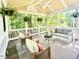 Inviting screened porch featuring comfortable seating and views of the surrounding greenery at 13017 Townfield Dr, Raleigh, NC 27614