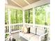 Relaxing screened patio with a cozy sofa, offering views of the serene wooded landscape at 13017 Townfield Dr, Raleigh, NC 27614