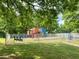 View of the community playground with metal fencing at 13017 Townfield Dr, Raleigh, NC 27614