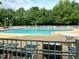 Community pool with plenty of lounge seating and mature trees nearby at 13017 Townfield Dr, Raleigh, NC 27614