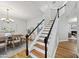 Elegant staircase leading to the upper level, complemented by hardwood floors and modern decor at 13017 Townfield Dr, Raleigh, NC 27614