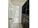 Organized walk-in closet with custom shelving system, leading to an ensuite bathroom at 13017 Townfield Dr, Raleigh, NC 27614