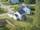 Aerial view of backyard and multi-story home with screened-in porch at 1309 Magnolia Gln Cir, Wake Forest, NC 27587