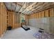 Unfinished basement with exposed framing and a treadmill exercise area at 1309 Magnolia Gln Cir, Wake Forest, NC 27587