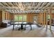 Unfinished basement with exposed framing, insulation, and a ping pong table at 1309 Magnolia Gln Cir, Wake Forest, NC 27587