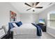 Cozy bedroom featuring a ceiling fan, TV, and comfortable bed with blue accents at 1309 Magnolia Gln Cir, Wake Forest, NC 27587