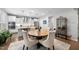 Cozy dining area with a stylish table and chairs, adjacent to a modern kitchen with stainless appliances at 1309 Magnolia Gln Cir, Wake Forest, NC 27587