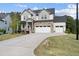 Beautiful two-story home with stone details, a three-car garage, and an expansive, well-kept lawn at 1309 Magnolia Gln Cir, Wake Forest, NC 27587