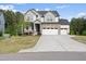 Charming two-story home with stone accents, three car garage, and a well-maintained lawn at 1309 Magnolia Gln Cir, Wake Forest, NC 27587