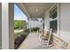Relaxing front porch with rocking chairs, offering a charming outdoor seating area at 1309 Magnolia Gln Cir, Wake Forest, NC 27587