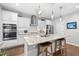 Bright kitchen features white cabinets, stainless appliances, granite counters, and pendant lighting at 1309 Magnolia Gln Cir, Wake Forest, NC 27587