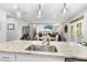 Kitchen island with granite counter, sink, and seating; view of the open concept floor plan at 1309 Magnolia Gln Cir, Wake Forest, NC 27587