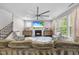 Spacious living room featuring hardwood floors, a fireplace, and comfortable seating for entertaining at 1309 Magnolia Gln Cir, Wake Forest, NC 27587