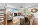 Bright living room with a ceiling fan, fireplace, large windows, and comfortable seating arrangement at 1309 Magnolia Gln Cir, Wake Forest, NC 27587
