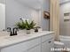 Bathroom featuring a double sink vanity, a large mirror, and a tub-shower combination at 15 Celtic Ln, Lillington, NC 27546