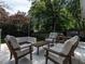 Backyard deck with outdoor seating, grilling area, and mature landscaping at 1510 Hanover St, Raleigh, NC 27608