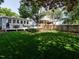 Spacious backyard featuring a well-maintained lawn and a cozy deck with outdoor furniture, ideal for entertaining at 1510 Hanover St, Raleigh, NC 27608