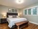 Bedroom features hardwood floors and a bed with a rustic wooden bench at 1510 Hanover St, Raleigh, NC 27608