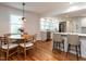 Open dining area with hardwood floors, a pendant light, and views of the kitchen at 1510 Hanover St, Raleigh, NC 27608