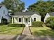 Charming one-story home with a well-manicured lawn, inviting front porch, and vibrant landscaping at 1510 Hanover St, Raleigh, NC 27608