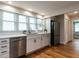 Well-lit kitchen featuring white cabinets, stainless appliances, and an open layout at 1510 Hanover St, Raleigh, NC 27608