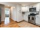 Modern kitchen featuring white cabinets, stainless steel appliances, and hardwood floors at 1510 Hanover St, Raleigh, NC 27608