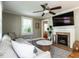 Cozy living room with a fireplace, ceiling fan, hardwood floors, and lots of natural light at 1510 Hanover St, Raleigh, NC 27608