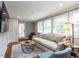 Spacious living room with large windows, hardwood floors, and modern furnishings at 1510 Hanover St, Raleigh, NC 27608