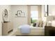 Cozy bedroom with soft textures, natural light from the large window, and modern decor at 1552 Bright Coral Trl, Wendell, NC 27591