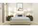Bright bedroom featuring neutral tones, stylish furniture, and a decorative animal print over the bed at 1552 Bright Coral Trl, Wendell, NC 27591