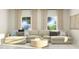 Bright living room featuring a large sectional sofa, round coffee table, and natural light from the windows at 1552 Bright Coral Trl, Wendell, NC 27591