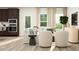 Open-concept living room with dark wood cabinets, stainless steel appliances, and comfortable seating at 1552 Bright Coral Trl, Wendell, NC 27591